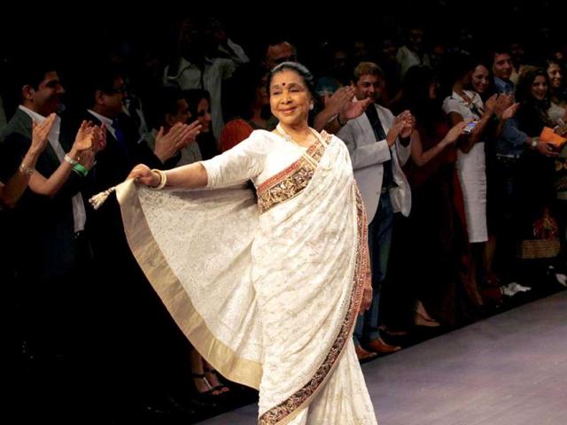 Legendary singer Asha Bhosle enchanted the ramp with her charming personality during Lakme fashion Week on Friday. (AP Photo)