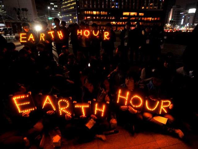 South Korean students hold Earth Hour LED displays during the 7th annual Earth Hour global warming campaign in Seoul. AFP