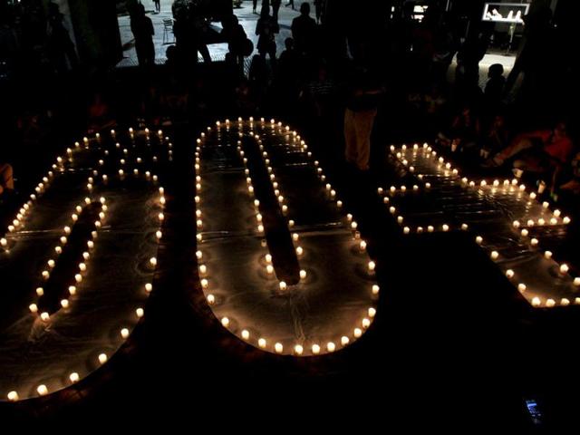 People sit near candles during Earth Hour, after lights were turned off in the city of Cali People sit near candles during Earth Hour, after lights were turned off in the city of Cali. Reuters photo