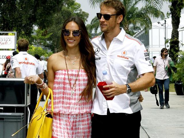 McLaren driver Jenson Button of Britain, right, and his girlfriend Jessica Michibata arrive at the Malaysian Formula One Grand Prix in Sepang, Malaysia. AP Photo