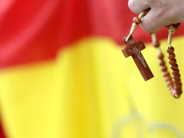 A faithful holds a rosary during the Palm Sunday mass led by Pope Francis at Saint Peter's Square at the Vatican. Reuters