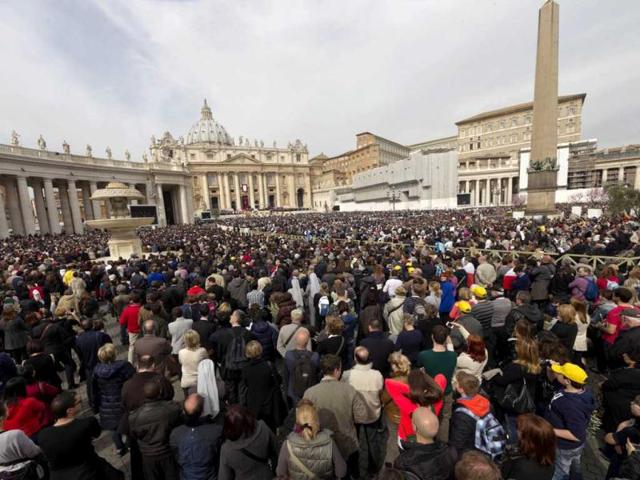Faithful listen to Pope Francis' message during his first Palm Sunday Mass in St. Peter's Square at the Vatican. AP
