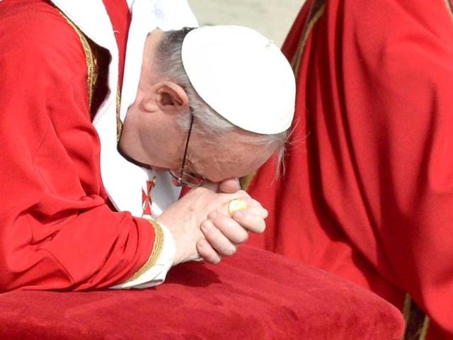 Pope Francis prays during a mass at St Peter's Square on Palm Sunday at the Vatican. AFP