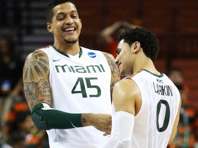 Shane Larkin celebrates with Julian Gamble of the Miami Hurricanes after their win over the Illinois Fighting Illini during the third round of the 2013 NCAA Men's Basketball Tournament at The Frank Erwin Center in Austin, Texas. AFP