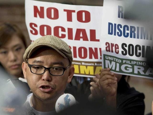 Eman Villanueva, spokesman for the labor rights group Asian Migrants Coordinating Body, addresses the media after a decision was handed down in a domestic helper permanent residency legal case, outside of the high court in Hong Kong. AFP