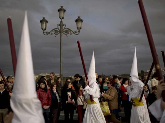 Penitents from "San Gonzalo" brotherhood take part in a procession in Seville, Spain. Hundreds of processions take place throughout Spain during the Easter Holy Week. AP