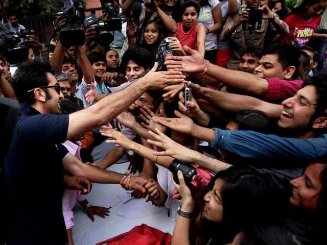 Ranbir Kapoor shakes hands with his fans during a charity football match in New Delhi on Thursday. PTI Photo