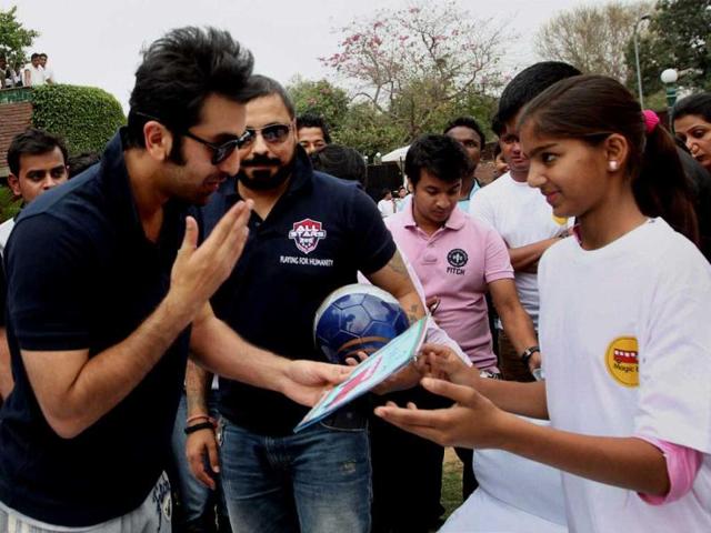Ranbir Kapoor interacts with a girl during a charity football match in New Delhi on Thursday. PTI Photo