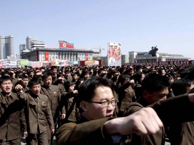 North Koreans punch the air during a rally at Kim Il Sung Square in downtown Pyongyang, North Korea. Tens of thousands of North Koreans turned out for the mass rally at the main square in Pyongyang in support of their leader Kim Jong Un's call to arms. (AP Photo)