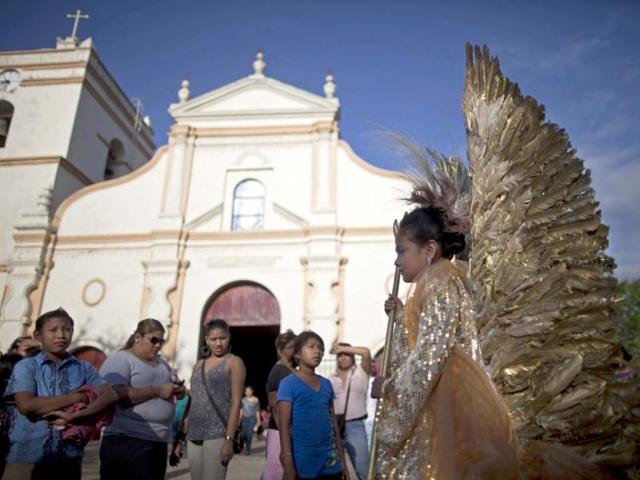 A girl wearing an angel costume wait for the start of a Good Friday procession in Masaya. (AP)