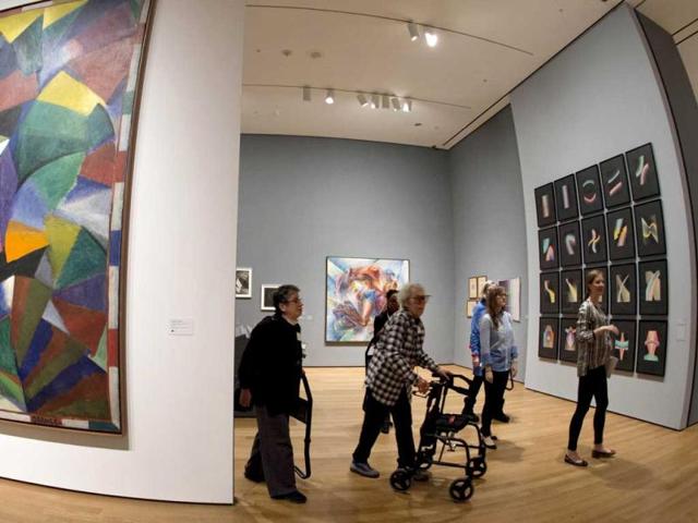 A small group with various levels of impaired vision tour an exhibit called Inventing Abstraction at the Museum of Modern Art in New York. (AFP Photo)