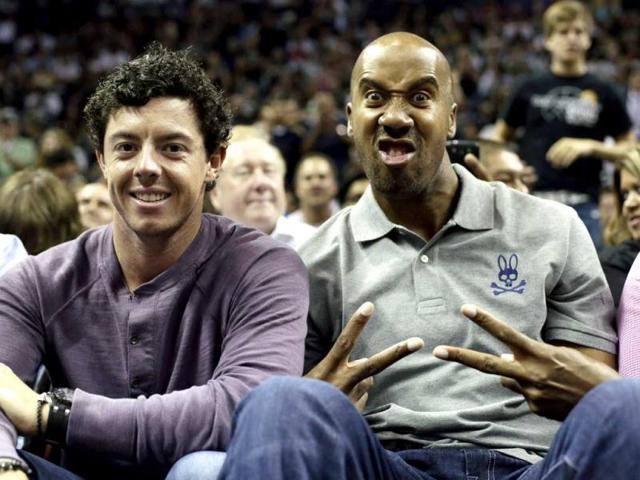 Rory McIlroy and former San Antonio Spurs forward Bruce Bowen, pose for a photo during the second half of an NBA basketball game between the San Antonio Spurs and Miami Heat in San Antonio. Miami won 88-86. (AP)