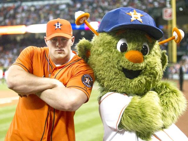 Defensive end JJ Watt of the Houston Texans poses with Houston Astros mascot Orbit after throwing out the first pitch during opening night at Minute Maid Park as the Texas Rangers played the Houston Astros in Houston, Texas. (AFP)