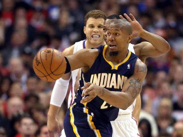David West of the Indiana Pacers passes the ball while defended by Willie Green and Blake Griffin of the Los Angeles Clippers in the first half at Staples Center in Los Angeles, California. AFP