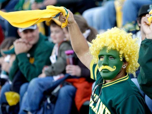 An Oakland Athletics fan cheers for the Athletics during a pregame ceremony before their game against the Seattle Mariners on Opening Day at Coliseum in Oakland, California. AFP
