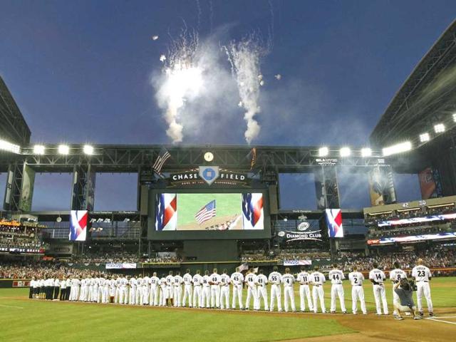 Arizona Diamondbacks players stand along the third base line during Opening Day festivities before the start of their MLB National League baseball game against the St. Louis Cardinals in Phoenix, Arizona. Reuters