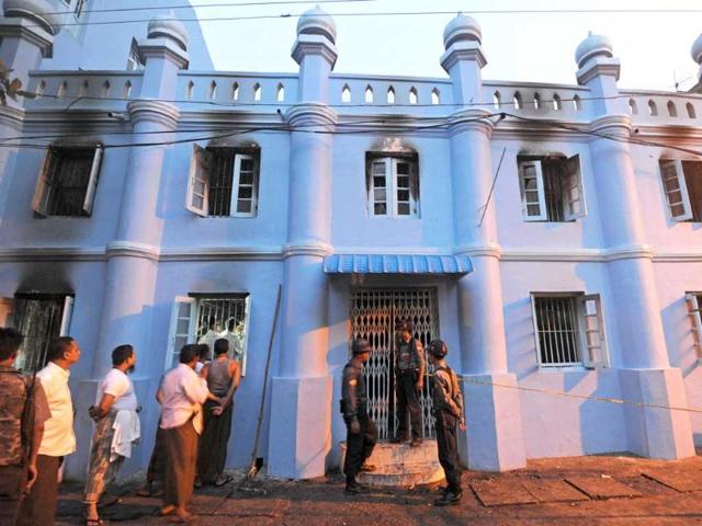 Policemen stand guard in front of the Islamic school after a fire broke out at the school in downtown Yangon. AFP