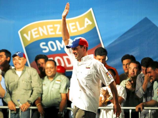 Venezuela's opposition leader and presidential candidate Henrique Capriles waves to supporters during a campaign rally in Caracas. Reuters