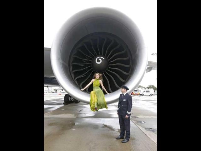British model Georgia May Jagger poses for a picture in front of one of the turbine engines of a new British Airways 777-700ER aircraft at Sydney Airport. (Reuters)