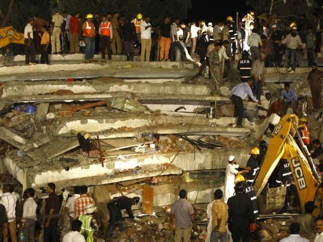 Rescue workers look for trapped people within the debris of the collapsed building in Thane that has claimed 30 lives till now. (AP)