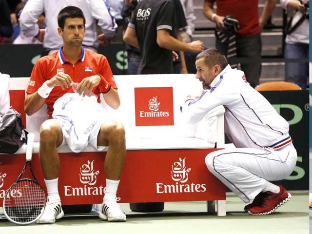 Serbia's Novak Djokovic (L) sit next to team captain Bogdan Obradovic on the bench during their Davis Cup quarter-final tennis match against John Isner of the US in Boise, Idaho. Reuters photo
