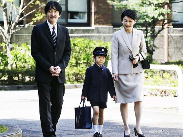 Prince Hisahito (C) accompanied by his parents Prince Akishino (L) and Princess Kiko, arrive at Ochanomizu University Elementary School for his entrance ceremony in Tokyo. AFP