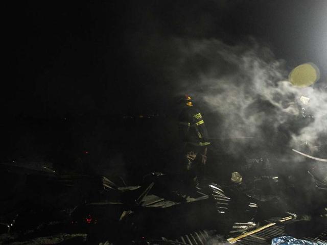 A Bangladeshi firefighter attempts to extinguish a blaze at a market in Dhaka. More then 100 shops burnt as a blaze tore through a market at the middle of the night. AFP