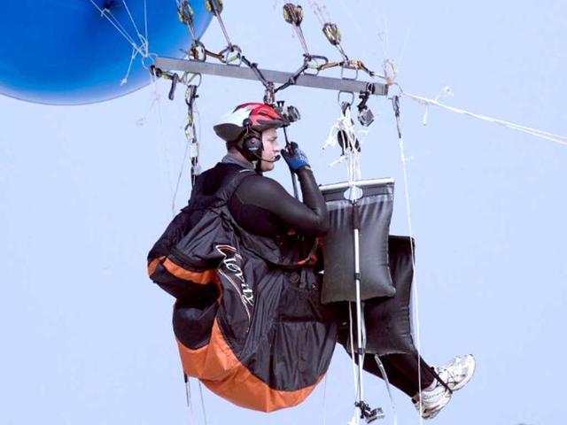 Matt Silver-Vallance gets ready prior to fly from Nelson Mandela's apartheid island prison using helium-filled giant party balloons in Cape Town. AFP