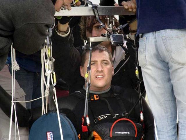 Matt Silver-Vallance gets ready prior to flew across the sea from Nelson Mandela's apartheid island prison using helium-filled giant party balloons in Cape Town.AFP