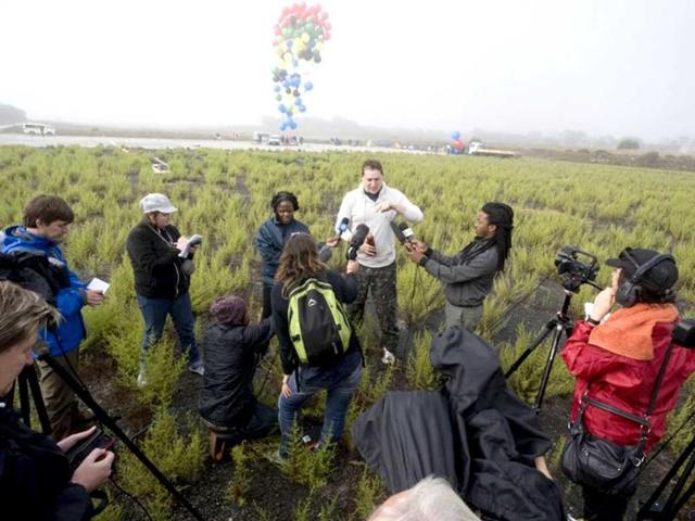 Matt Silver-Vallance talks to the press prior to flew across the sea from Nelson Mandela's apartheid island prison using helium-filled giant party balloons in Cape Town. AFP
