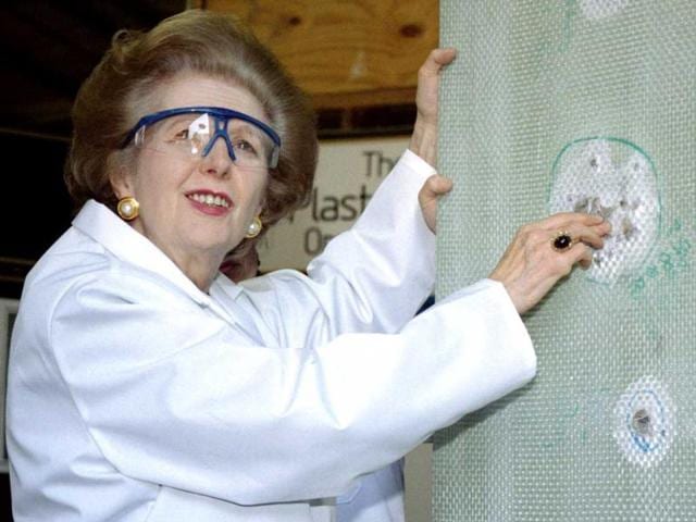 Baroness Margaret Thatcher examines a sheet of bullet-proof material during a visit to a factory producing ballistic and blast protection products. Reuters
