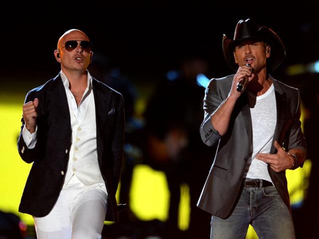 Pitbull, left, and Tim McGraw perform at ACM Presents: Tim McGraw's Superstar Summer Night at the MGM Grand Garden Arena in Las Vegas. (AP Photo)