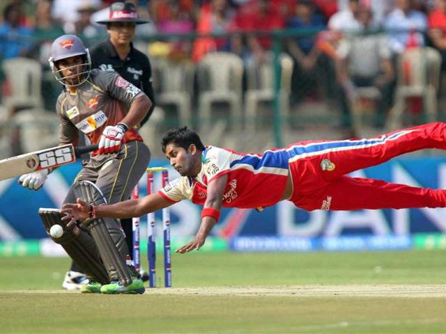 Royal Challengers Bangalore's Vinay Kumar dives to stop the ball during the IPL match against Sunrisers Hyderabad at Chinnaswamy Stadium in Bengaluru. PTI