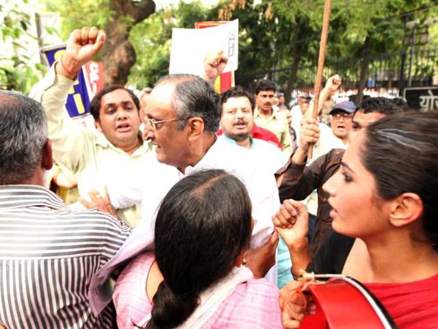 West Bengal finance minister Amit Mitra was heckled and had his shirt torn off by Students Federation of India activists outside the planning commission in New Delhi. HT