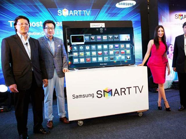 Yami Gautam(R) with SK Kim, Sr. Vice President, Consumer Electronics, Samsung India pose during the launch of the Samsung Smart TV at a press conference in Bengaluru. (PTI Photo)