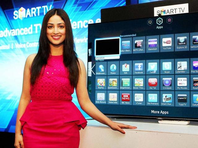 Yami Gautam looked smart in a cute, pink dress at the launch of Samsung Smart TV in Bangalore. Take a look as she poses for the lenses at the event. (PTI Photo)