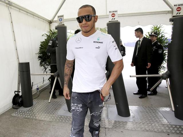 Mercedes driver Lewis Hamilton of Britain arrives at the circuit ahead of the Chinese Formula One Grand Prix in Shanghai, China. (AP Photo/Eugene Hoshiko)