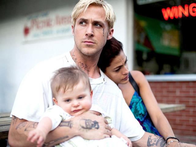 Directed by Derek Cianfrance, The Place Beyond the Pines depicts the struggle of stunt rider Luke (left) to raise his family.