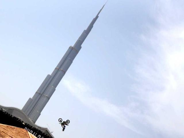 A motocross rider shows his skills during a training session outside Burj Khalifa on the eve of the 2013 Red Bull X-Fighters World Tour in the Gulf emirate of Dubai. AFP