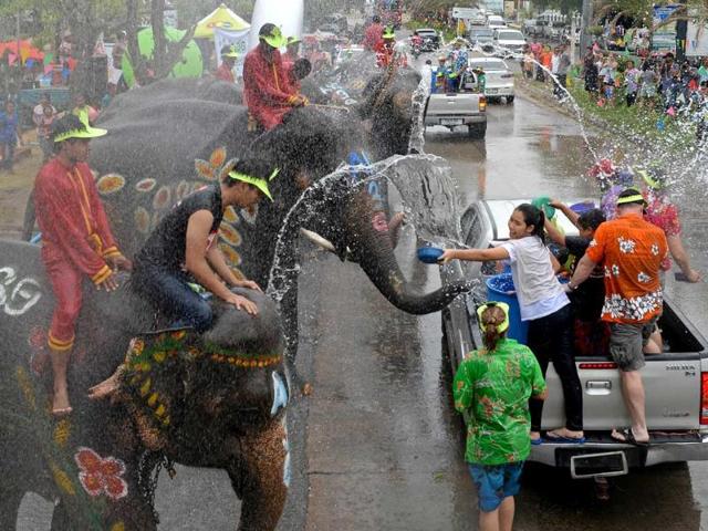 Thai people and foreign tourists take part in water battles with elephants as they join celebrations marking the Songkran Festival in Ayutthaya province. AFP