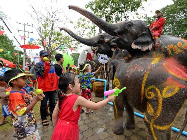 Thai children take part in water battles with elephants as they join celebrations marking the Songkran Festival in Ayutthaya province. AFP
