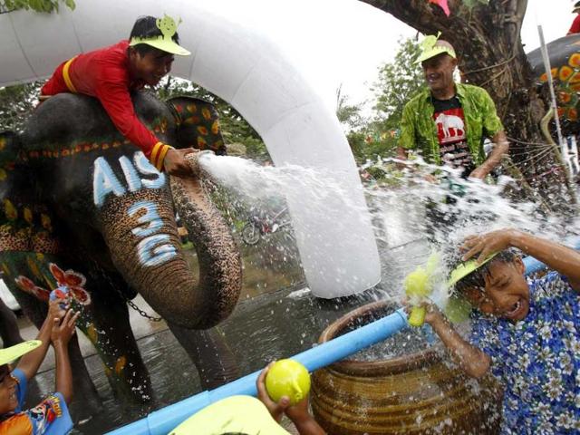 An elephant sprays water at children in celebration of the Songkran water festival in Thailand's Ayutthaya province, about 80km north of Bangkok. Reuters