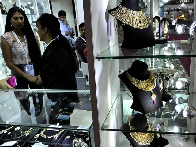 Exhibitors at their stall during the Gem and Jewellery Fair in New Delhi. HT Photo/Vipin Kumar