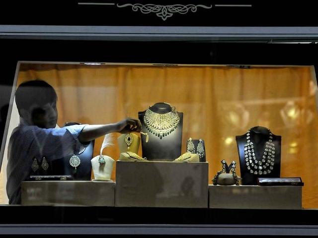 Exhibitors display jewellery its stall during the Gem and Jewellery Fair in New Delhi. HT Photo/Vipin Kumar