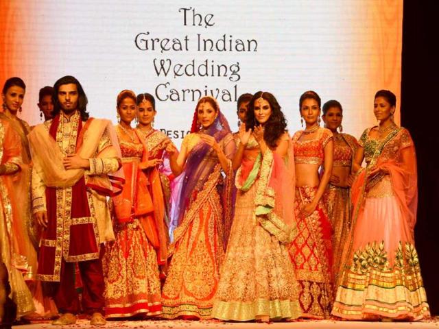 Neha Dhupia, displays jewellery during a fashion show at the India International Gem and Jewellery Fair in New Delhi on April 13, 2013. India now has 55 dollar billionaires, the fifth-biggest number in the world, according to a Forbes ranking this month, and the Indian luxury market as whole is forecast to reach USD 15 billion by 2015. AFP Photo