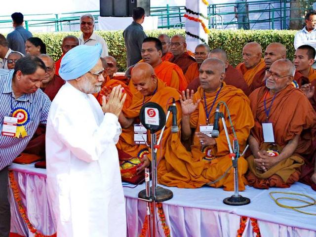 Prime Minister Manmohan Singh offering cloths to Monks after paying floral tribute to Baba Saheb Dr BR Ambedkar on the occasion of his birth anniversary at Parliament House. UNI PHOTO