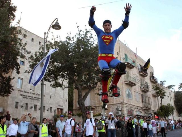 A man dressed as Superman jumps in the air during a parade in celebration of the Jewish holiday of Sukkot, in downtown Jerusalem. AFP photo