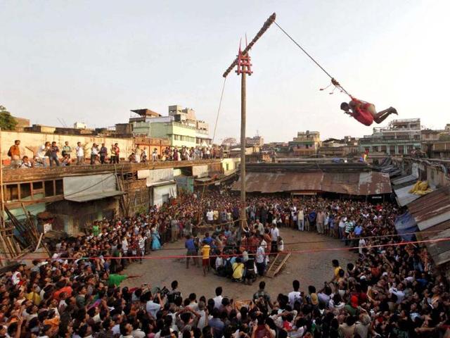 A devotee hangs from a rope during the Chadak ritual during celebration of Shiva Gajan in Kolkata.Reuters