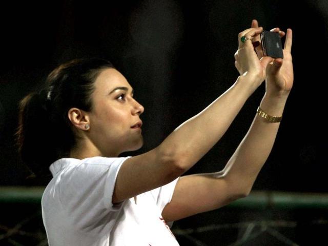 Kings XI Punjab's owner and actress Preity Zinta takes photo during the T20 match against Rajasthan Royals in Jaipur. PTI Photo