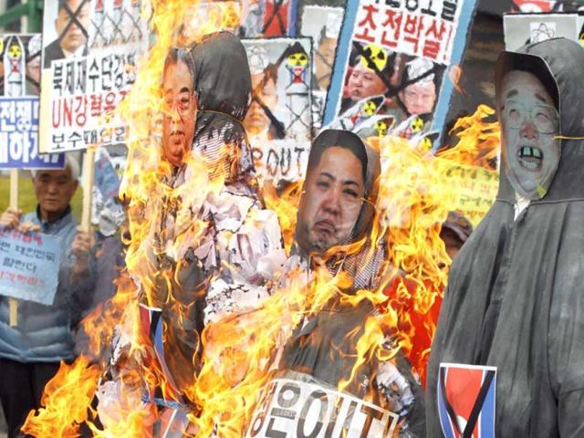 Anti-North Korean protesters from conservative, right-wing and pro-U.S. civic groups, burn effigies of late North Korean leader Kim Jong-il, current leader Kim Jong-un and the North's founder Kim Il-sung during a protest in central Seoul. North Korea celebrated the 101st anniversary of its founder's birth with flowers on Monday, although there was no sign of tension easing as South Korea warned that the North's survival could be in question without change and development. (Reuters)